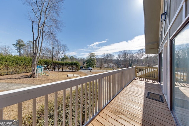 wooden deck featuring a playground