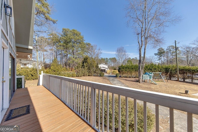 wooden deck featuring a playground