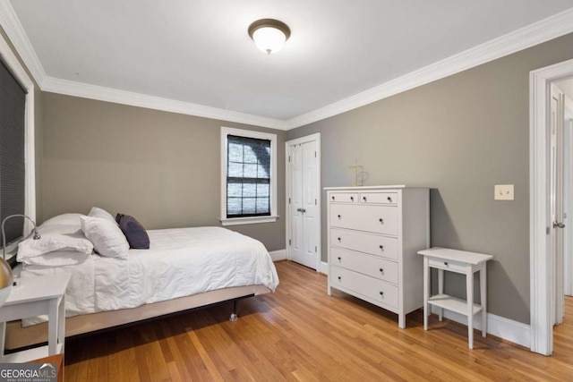 bedroom with light hardwood / wood-style flooring and ornamental molding