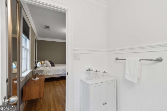 bathroom featuring crown molding and hardwood / wood-style floors