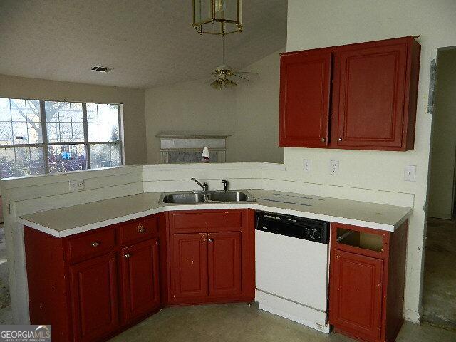 kitchen with sink, a textured ceiling, kitchen peninsula, and dishwasher