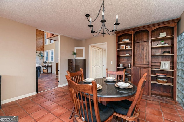 tiled dining area with a textured ceiling and an inviting chandelier