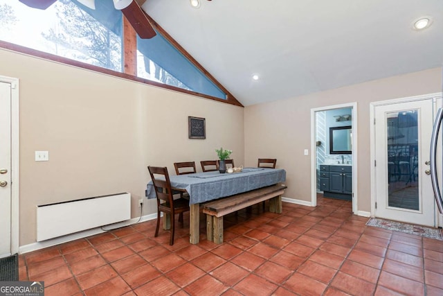 dining space with radiator heating unit, tile patterned floors, and high vaulted ceiling