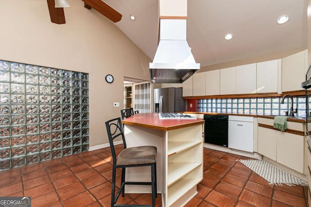 kitchen featuring dark tile patterned floors, white cabinetry, a kitchen breakfast bar, a kitchen island, and stainless steel fridge with ice dispenser