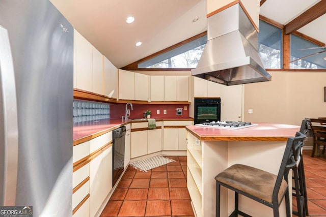 kitchen featuring a breakfast bar, vaulted ceiling, light tile patterned floors, island exhaust hood, and black appliances