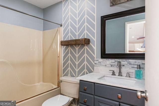 full bathroom with shower / bath combination, vanity, toilet, and decorative backsplash