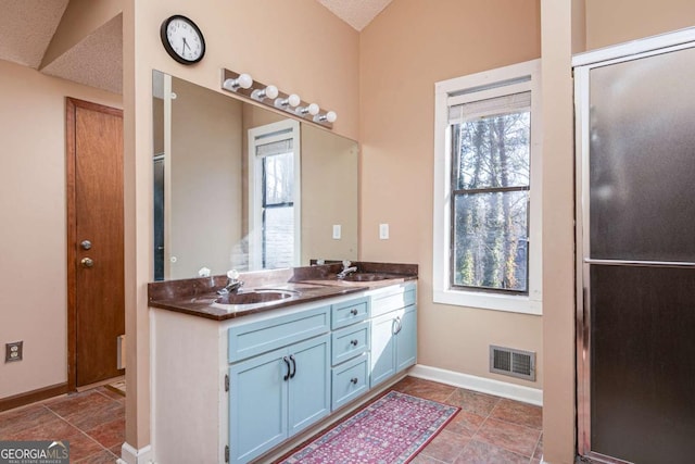 bathroom featuring vanity and a textured ceiling