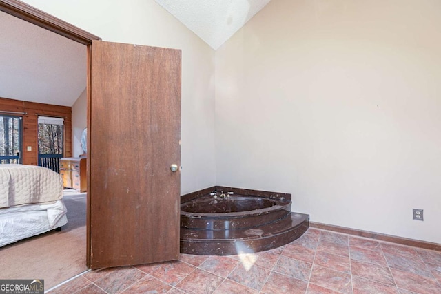 bathroom featuring a bathing tub, lofted ceiling, a textured ceiling, and wood walls