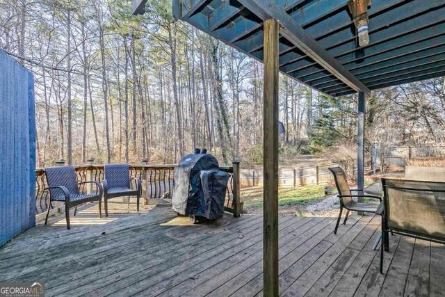 wooden terrace featuring a grill