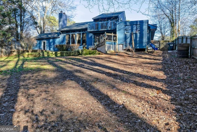 rear view of house with a wooden deck