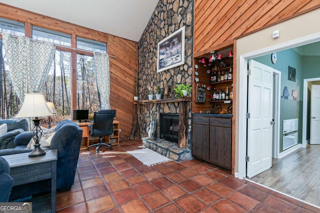 living room featuring a fireplace and wood walls