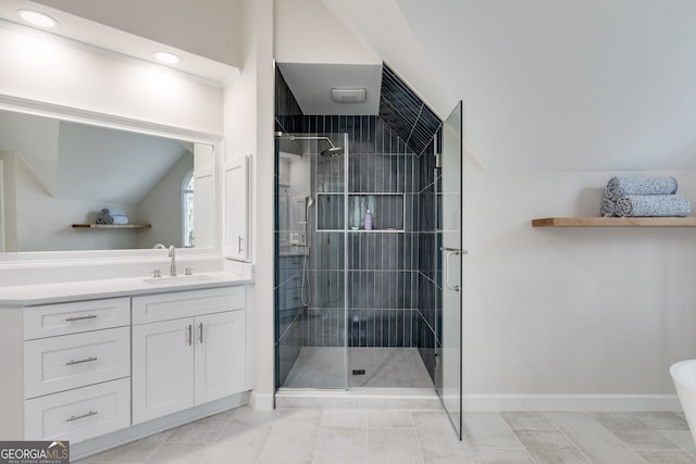 bathroom with lofted ceiling, a shower with door, and vanity