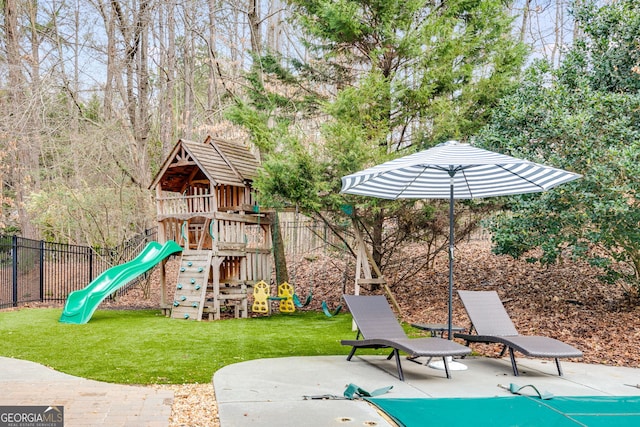 view of play area with a patio and a lawn