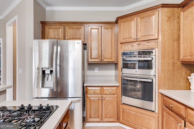 kitchen with ornamental molding and stainless steel appliances