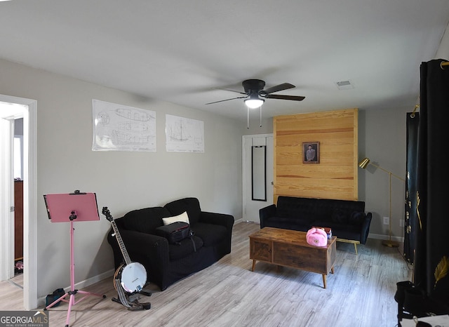 living room with ceiling fan and light wood-type flooring