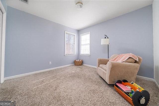 living area featuring carpet