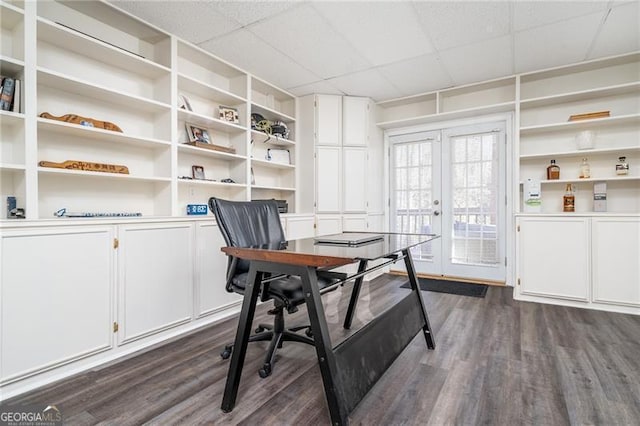 office with dark hardwood / wood-style flooring, french doors, and a drop ceiling