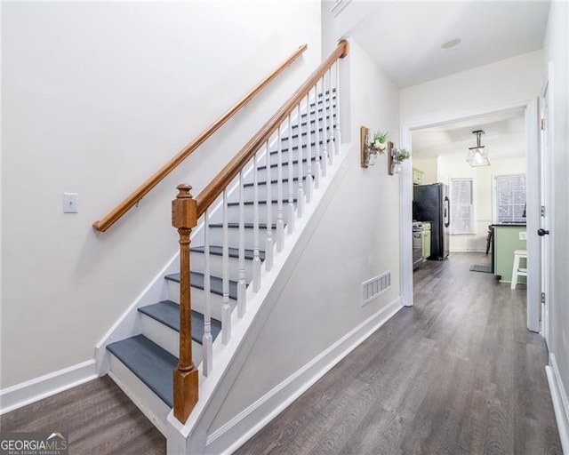 stairway featuring wood-type flooring