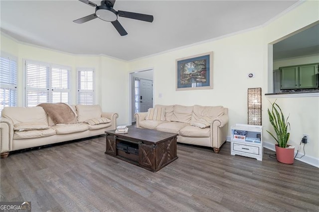 living room with dark hardwood / wood-style flooring, ornamental molding, and ceiling fan