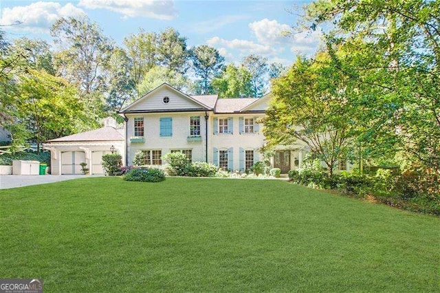 view of front of house with a garage and a front yard