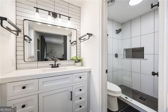 bathroom featuring vanity, toilet, and walk in shower