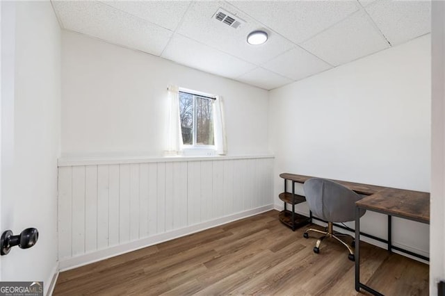 home office featuring a paneled ceiling and wood-type flooring