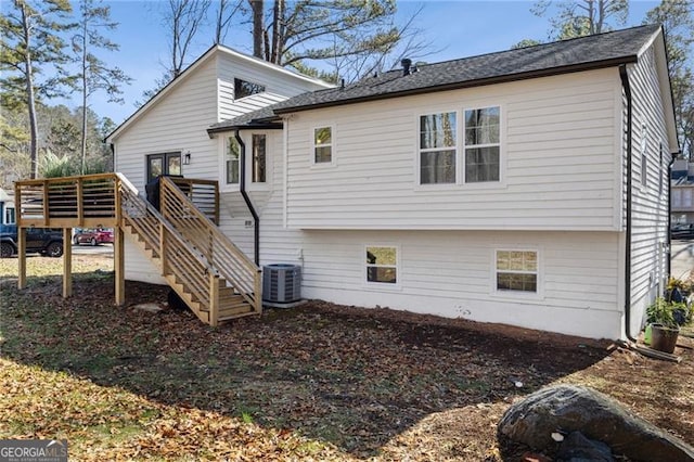 rear view of house featuring cooling unit and a deck