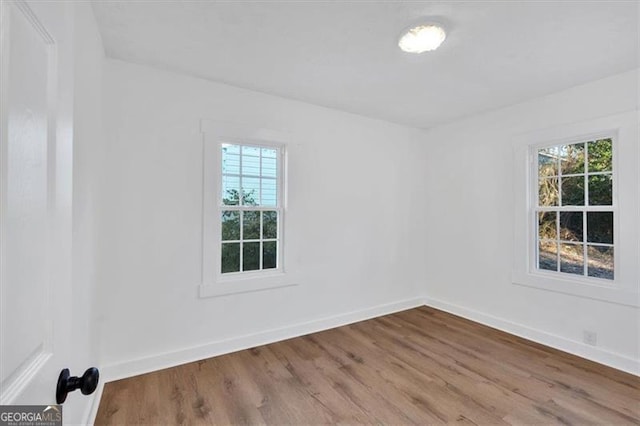 empty room featuring hardwood / wood-style flooring and plenty of natural light