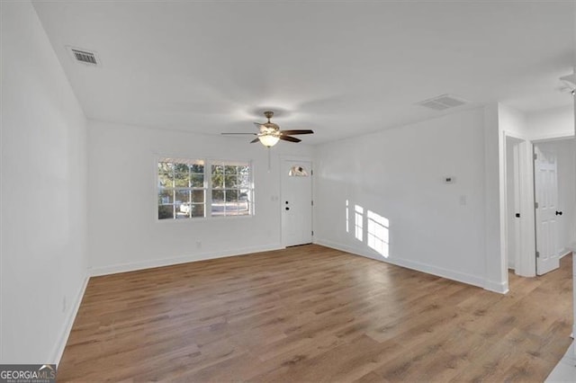 empty room with light hardwood / wood-style flooring and ceiling fan