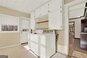 washroom with cabinets and separate washer and dryer