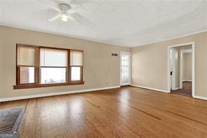 spare room with wood-type flooring and ceiling fan