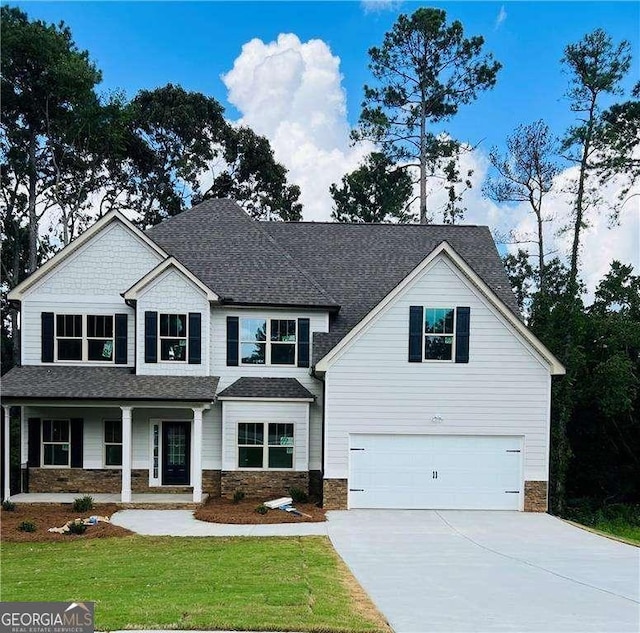 view of front facade with a garage and a front lawn