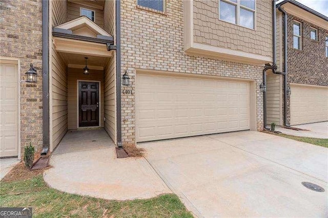 doorway to property with a garage