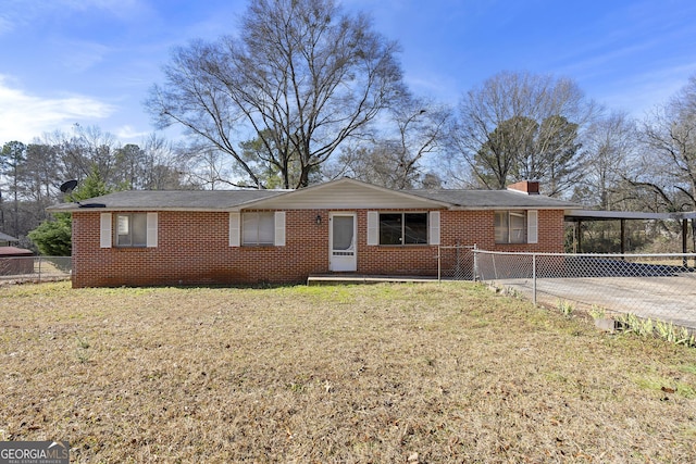 ranch-style house with a carport and a front yard