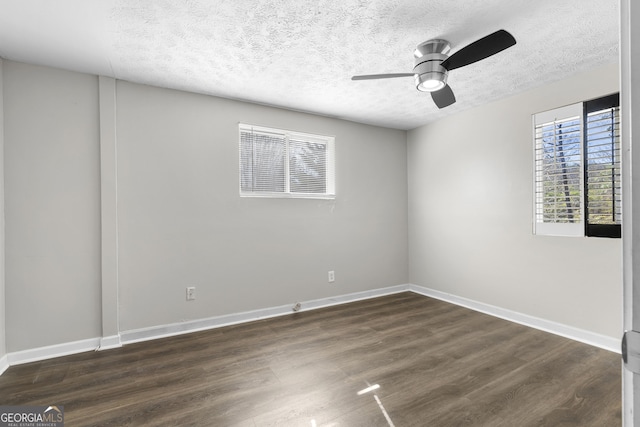 spare room with ceiling fan, dark hardwood / wood-style flooring, and a textured ceiling