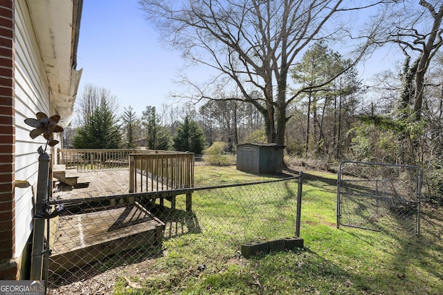 view of yard featuring a wooden deck and a storage unit