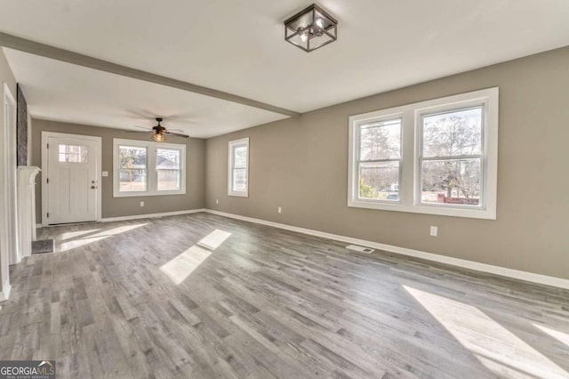 unfurnished living room with ceiling fan and light hardwood / wood-style floors