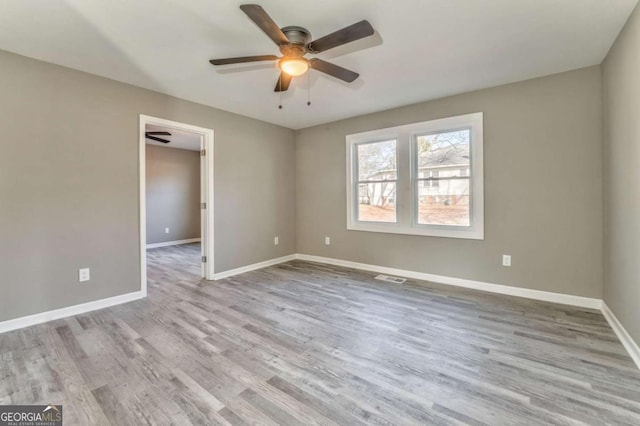 unfurnished room featuring ceiling fan and light hardwood / wood-style flooring