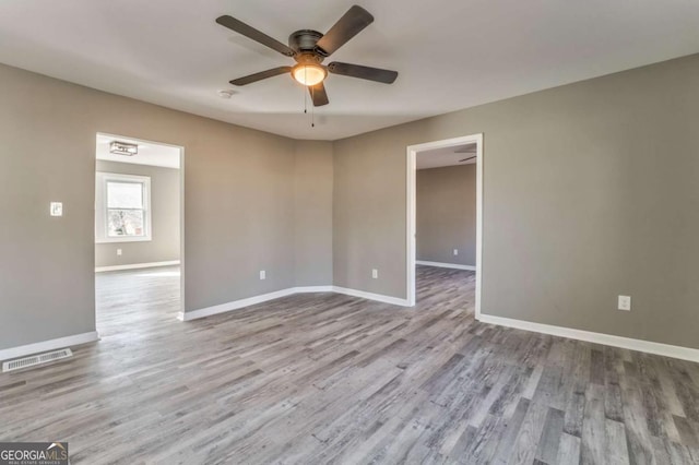 empty room featuring light hardwood / wood-style floors and ceiling fan