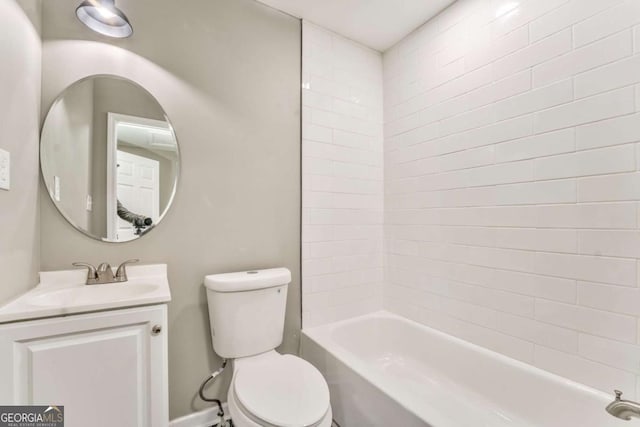 full bathroom with vanity, tiled shower / bath, and toilet