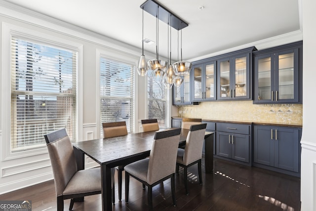 dining room with dark wood-type flooring and a chandelier