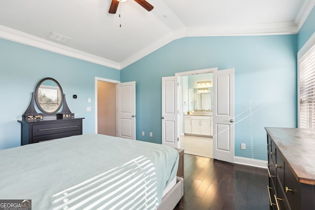 bedroom featuring vaulted ceiling, dark hardwood / wood-style floors, ensuite bathroom, and ornamental molding