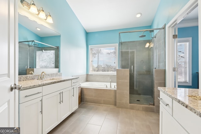 bathroom with plenty of natural light and shower with separate bathtub