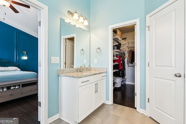 bathroom with hardwood / wood-style flooring, ceiling fan, and vanity