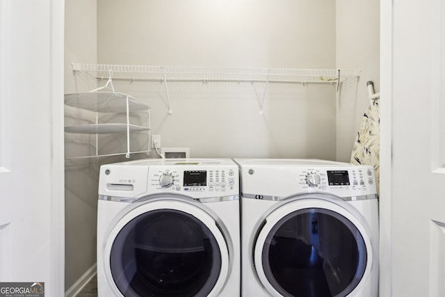 clothes washing area featuring washer and clothes dryer