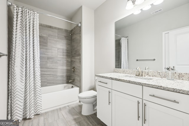 full bathroom with shower / bath combination with curtain, vanity, and toilet