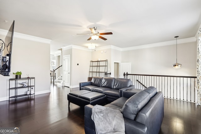 living room featuring dark wood-type flooring, ceiling fan, and crown molding