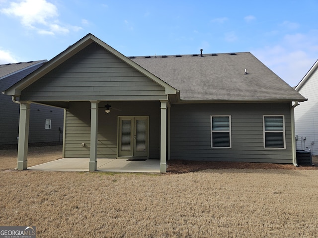 back of house with a patio area, ceiling fan, cooling unit, and roof with shingles