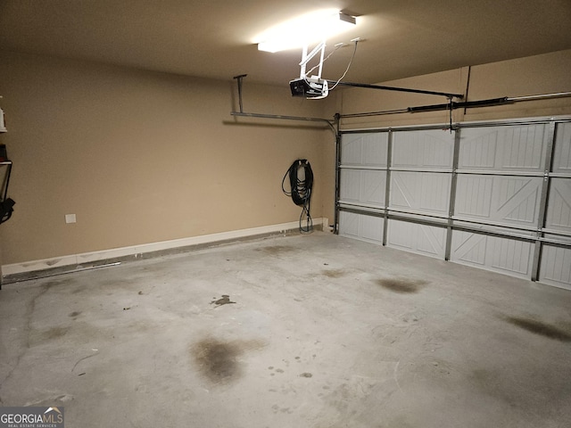 garage with baseboards and a garage door opener