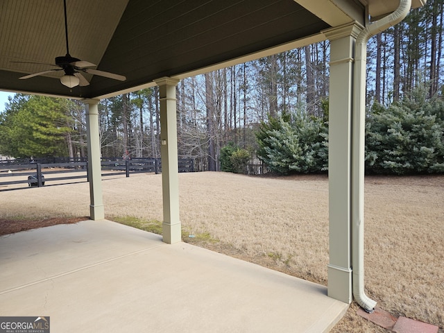 view of patio / terrace with ceiling fan and fence